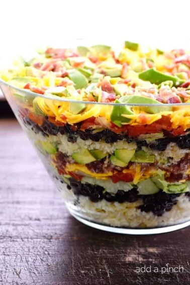 Mexican Cornbread Salad makes a delicious layered salad recipe using spicy Mexican cornbread, beans, tomatoes, and so much more! // addapinch.com