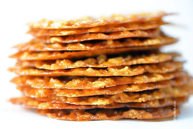 Photo of stack of Oatmeal Lace Cookies on white background.