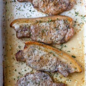 Baked pork chops in a white baking dish