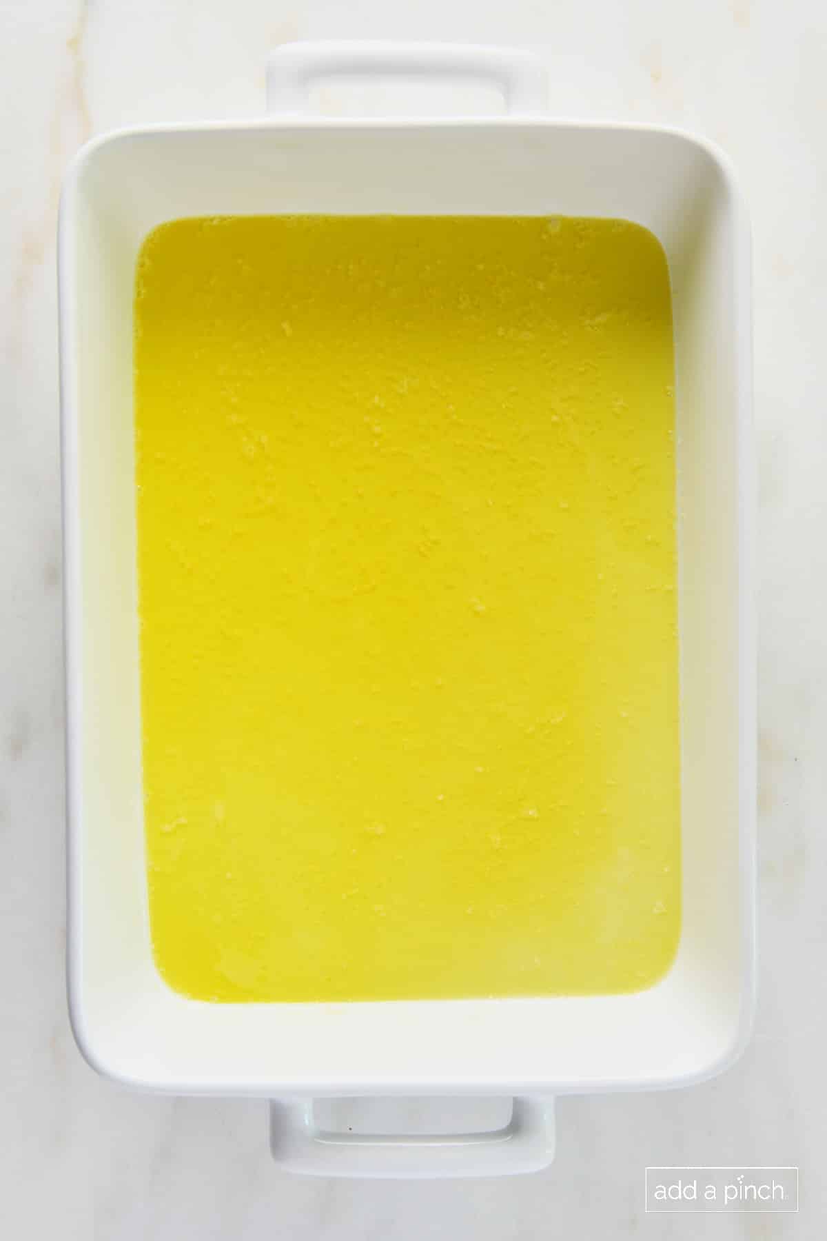 Melted butter in a white baking dish.