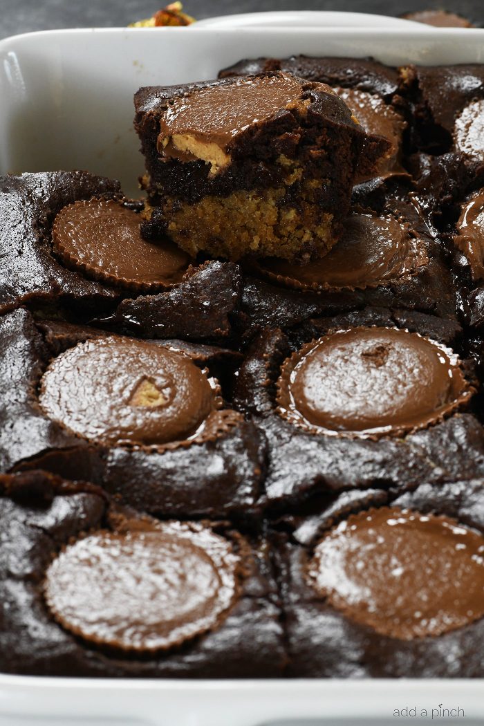 Peanut Butter Cup Brookies Recipe - This recipe takes brownies to a whole new level! Layers of chocolate chip cookie, fudgy brownies, and peanut butter cups make a dessert that everyone loves! // addapinch.com