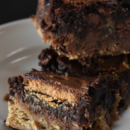 Peanut Butter Cup Brookies Recipe - This recipe takes brownies to a whole new level! Layers of chocolate chip cookie, fudgy brownies, and peanut butter cups make a dessert that everyone loves! // addapinch.com