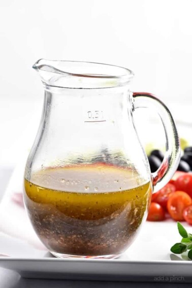 Homemade Italian Dressing Recipe - Homemade Italian Dressing is such a quick and easy salad dressing recipe! Made with olive oil, vinegar, herbs and spices, this Italian Dressing recipe is one that everyone always loves! // addapinch.com