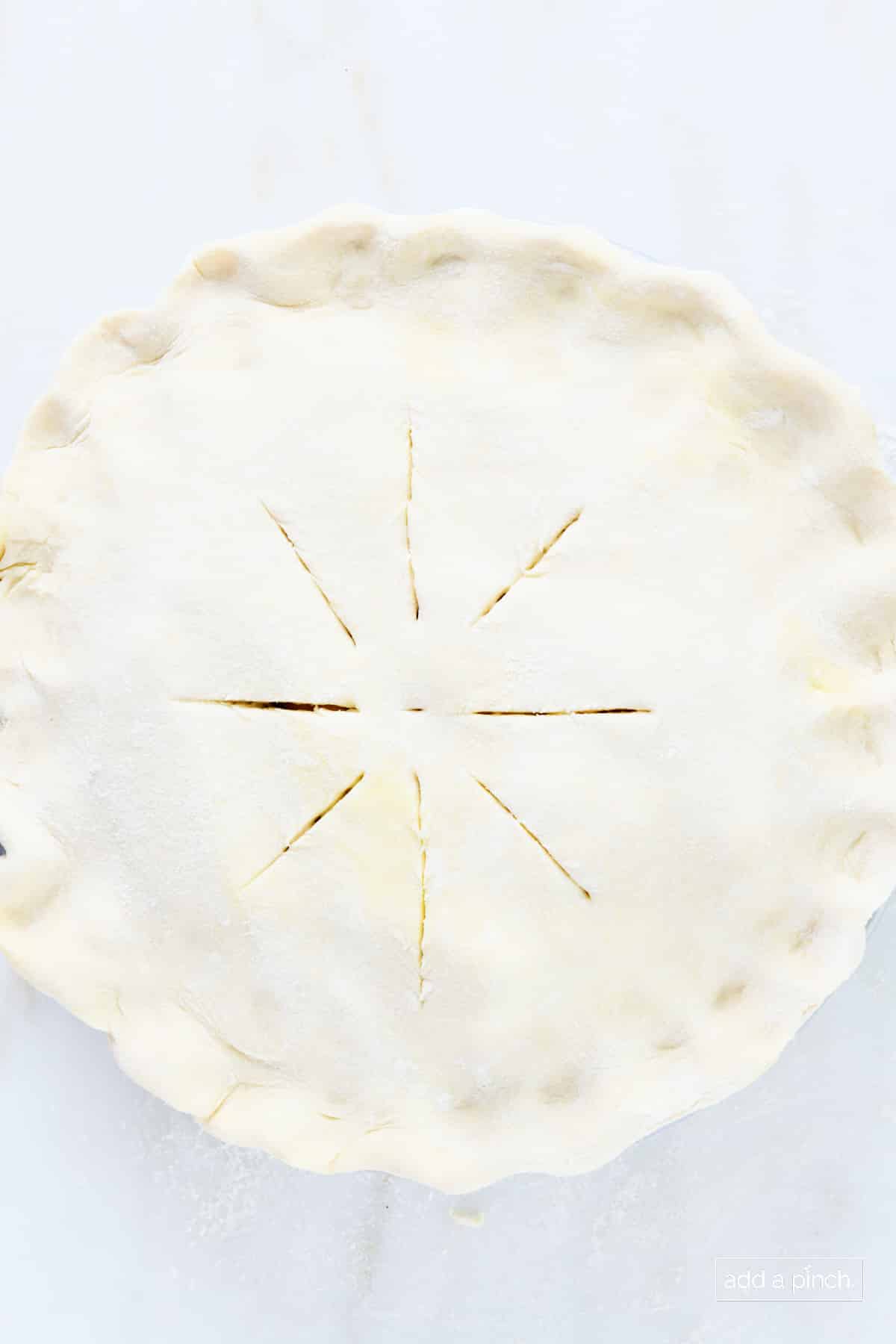 Double crust pie crust with slits cut into the top crust prior to baking.