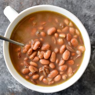 Pinto Beans Recipe - Slow cooked southern pinto beans that are a traditional favorite! Includes stove top, slow cooker and pressure cooker instructions! // addapinch.com