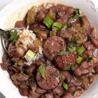 Bowl of red beans and rice with a spoon.
