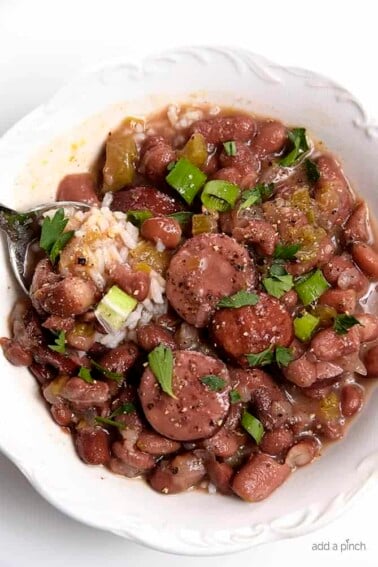 Bowl of red beans and rice with a spoon.