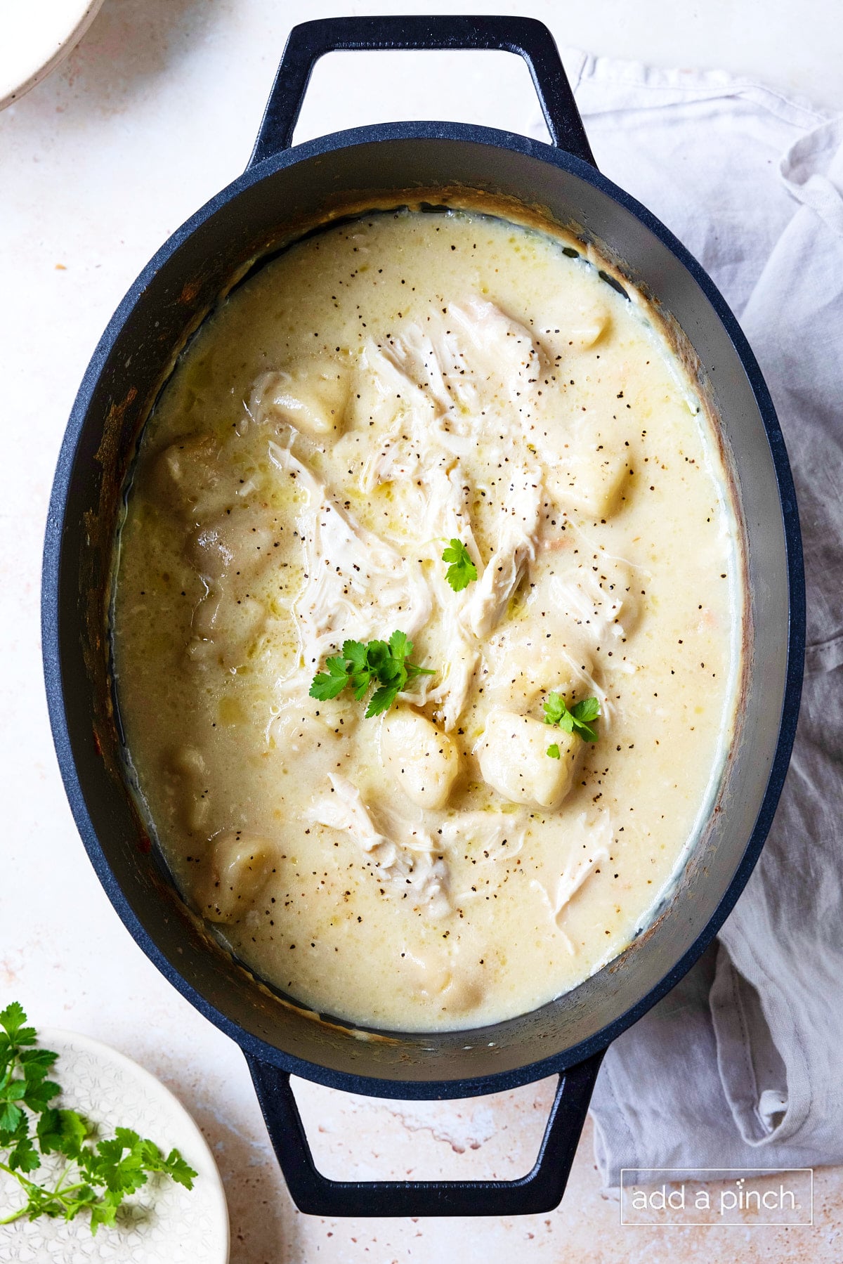 Cooked slow cooker chicken and dumplings ready to serve.