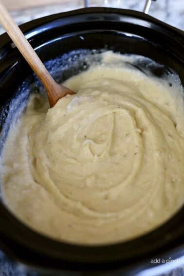 Slow Cooker Garlic Mashed Potatoes Recipe - This Slow Cooker Garlic Mashed Potatoes recipe makes an easy way to make a favorite side dish by letting the slow cooker do all the hard work! // addapinch.com