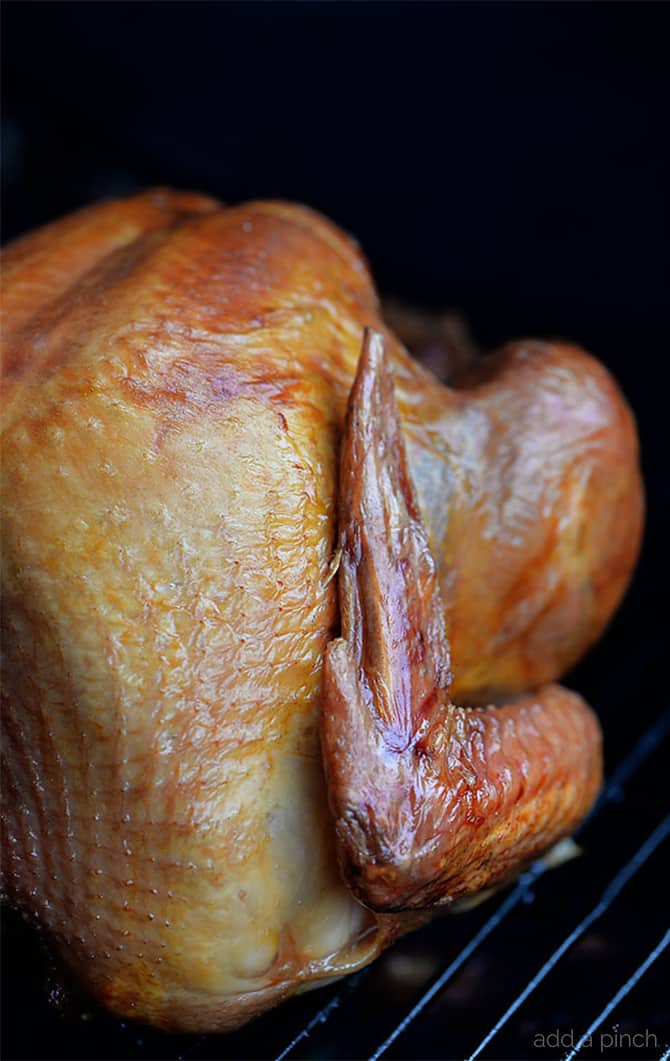Smoked Turkey Recipe - This simple, yet scrumptious smoked turkey brings the juiciest and most flavorful turkey to your Thanksgiving table.ย // addapinch.com