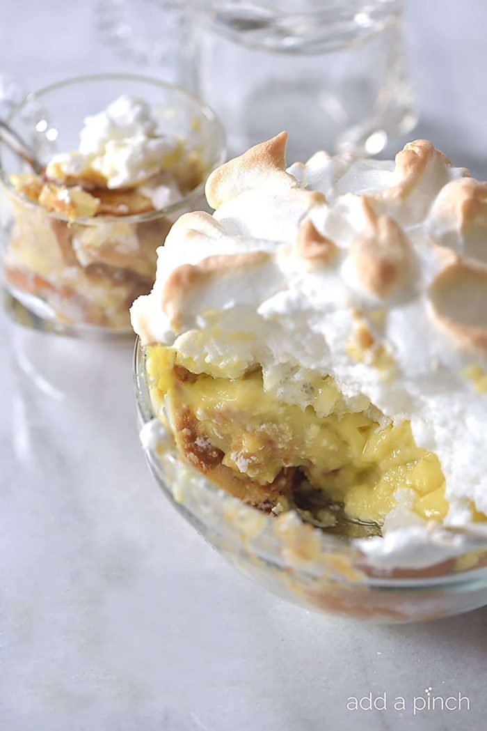 Banana Pudding with homemade Meringue in glass serving bowl // addapinch.com