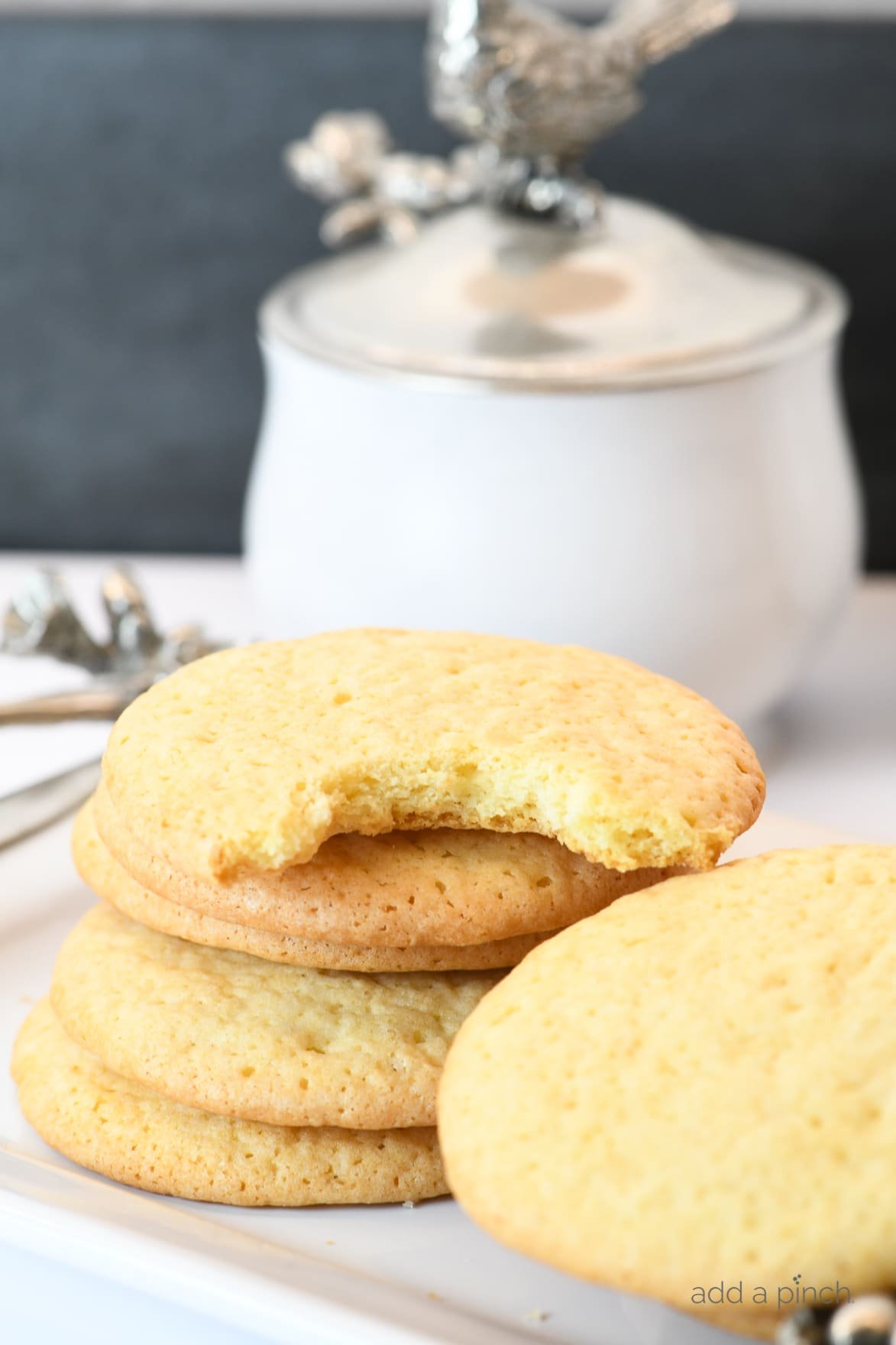 Photograph of stack of teacake cookies on a white platter.