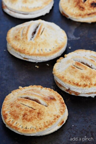 Strawberry Hand Pies Recipe - Simple strawberry hand pies are the cutest and simplest little portable pies perfect for sharing and devouring! // addapinch.com