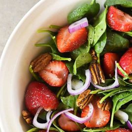 Strawberry Spinach Salad Recipe - Strawberry Spinach Salad topped with an easy Poppy Seed Dressing makes for a beautiful and delicious spring and summer salad recipe. Perfect for parties, picnics, and get-togethers! Always a crowd favorite.