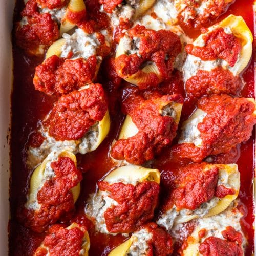 Photo of stuffed shells in a baking dish ready to be served.