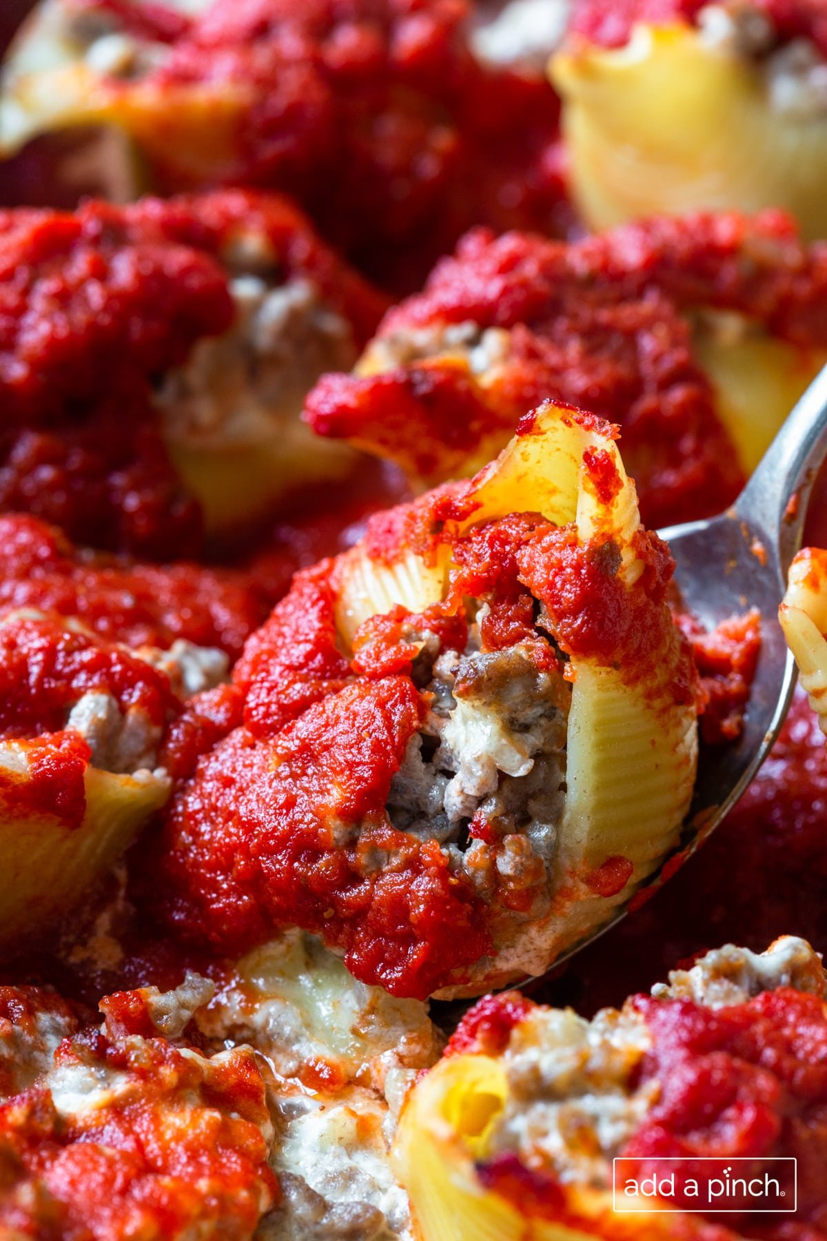 Photo of shells stuffed with beef, cheese and cooked in rich tomato sauce.