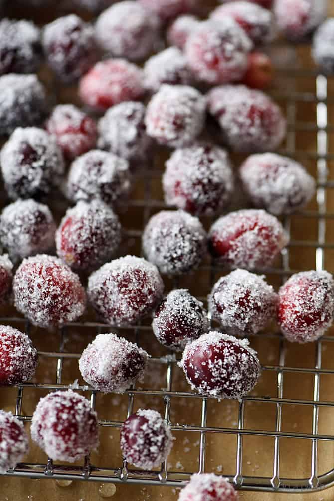 Cranberries have been rolled in sugar and placed atop wired rack over parchment paper // addapinch.com