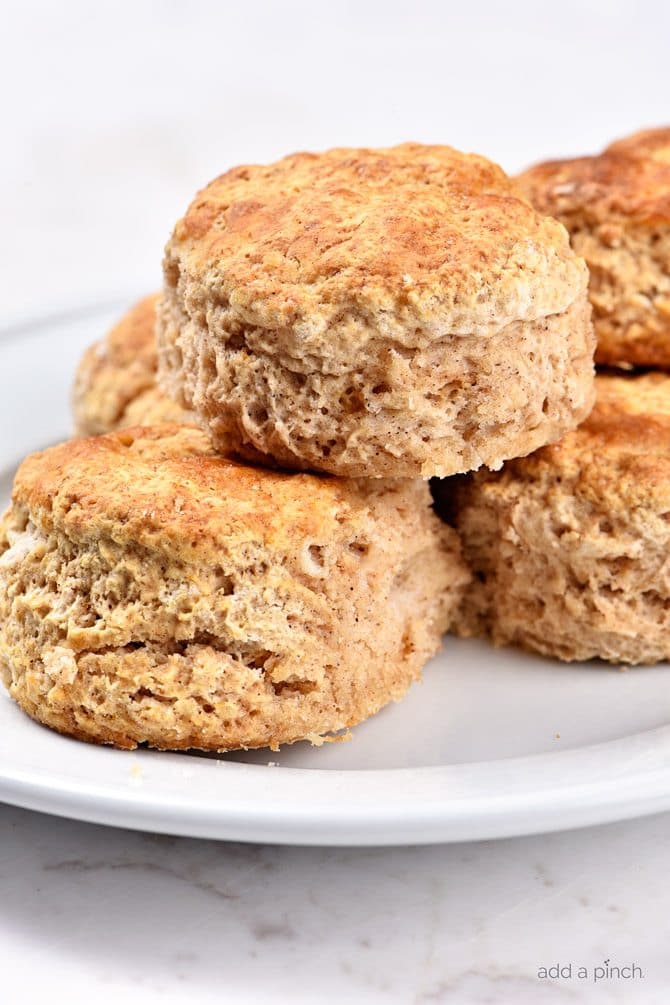 These Sweet Cinnamon Biscuits practically scream fall! But then, when you drizzle them with this Apple Cider Glaze, they become ethereal! So easy to prepare, this is one biscuit recipe that you will want to make again and again! // addapinch.com
