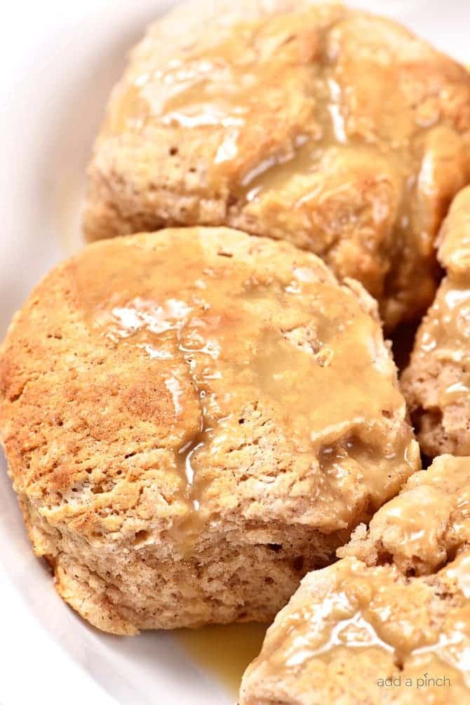 These Sweet Cinnamon Biscuits practically scream fall! But then, when you drizzle them with this Apple Cider Glaze, they become ethereal! So easy to prepare, this is one biscuit recipe that you will want to make again and again! // addapinch.com