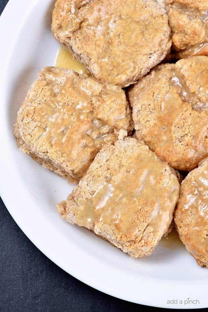 These Sweet Cinnamon Biscuits practically scream fall! But then, when you drizzle them with this Apple Cider Glaze, they become ethereal! So easy to prepare, this is one biscuit recipe that you will want to make again and again! // addapinch.com