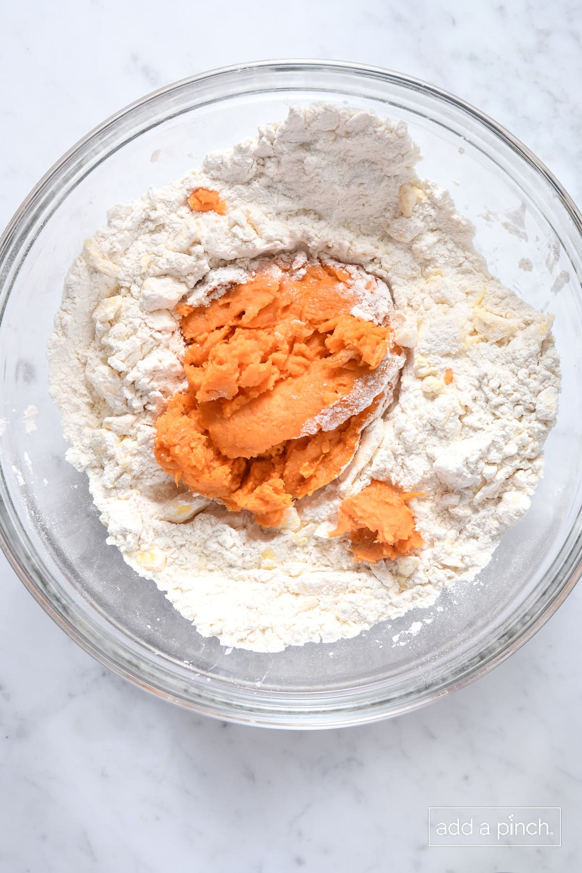 Adding cooked sweet potato to flour mixture.