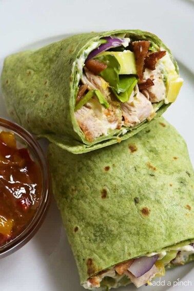 Sweet and Spicy Chicken Wraps - Quick, easy and oh so delicious! This chicken wraps recipe is made with chicken, bacon, cucumbers, red onions, and a special sweet and spicy spread! // addapinch.com