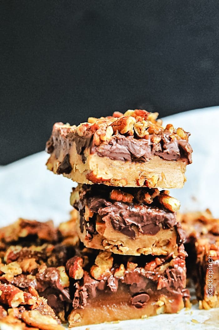 Photograph of homemade buttery toffee with a layer of chocolate and roasted pecans. 