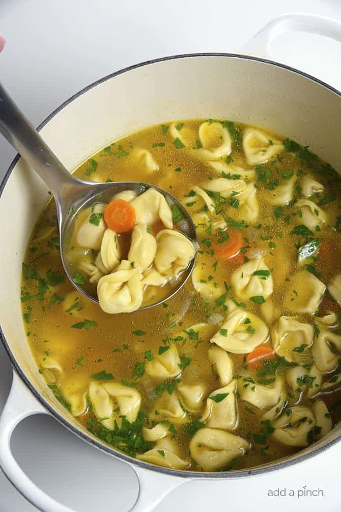 Tortellini Soup is perfect for busy nights! Made with vegetables, cheesy tortellini and topped with fresh parmesan! Ready and on the table in 30 minutes! // addapinch.com