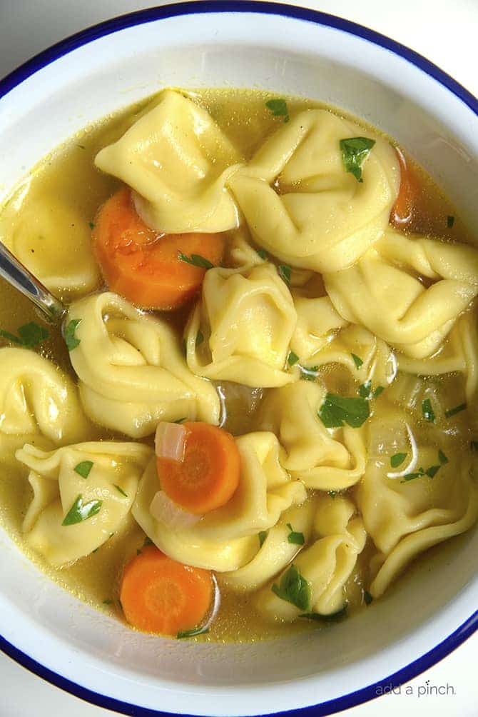 Tortellini Soup is perfect for busy nights! Made with vegetables, cheesy tortellini and topped with fresh parmesan! Ready and on the table in 30 minutes! // addapinch.com