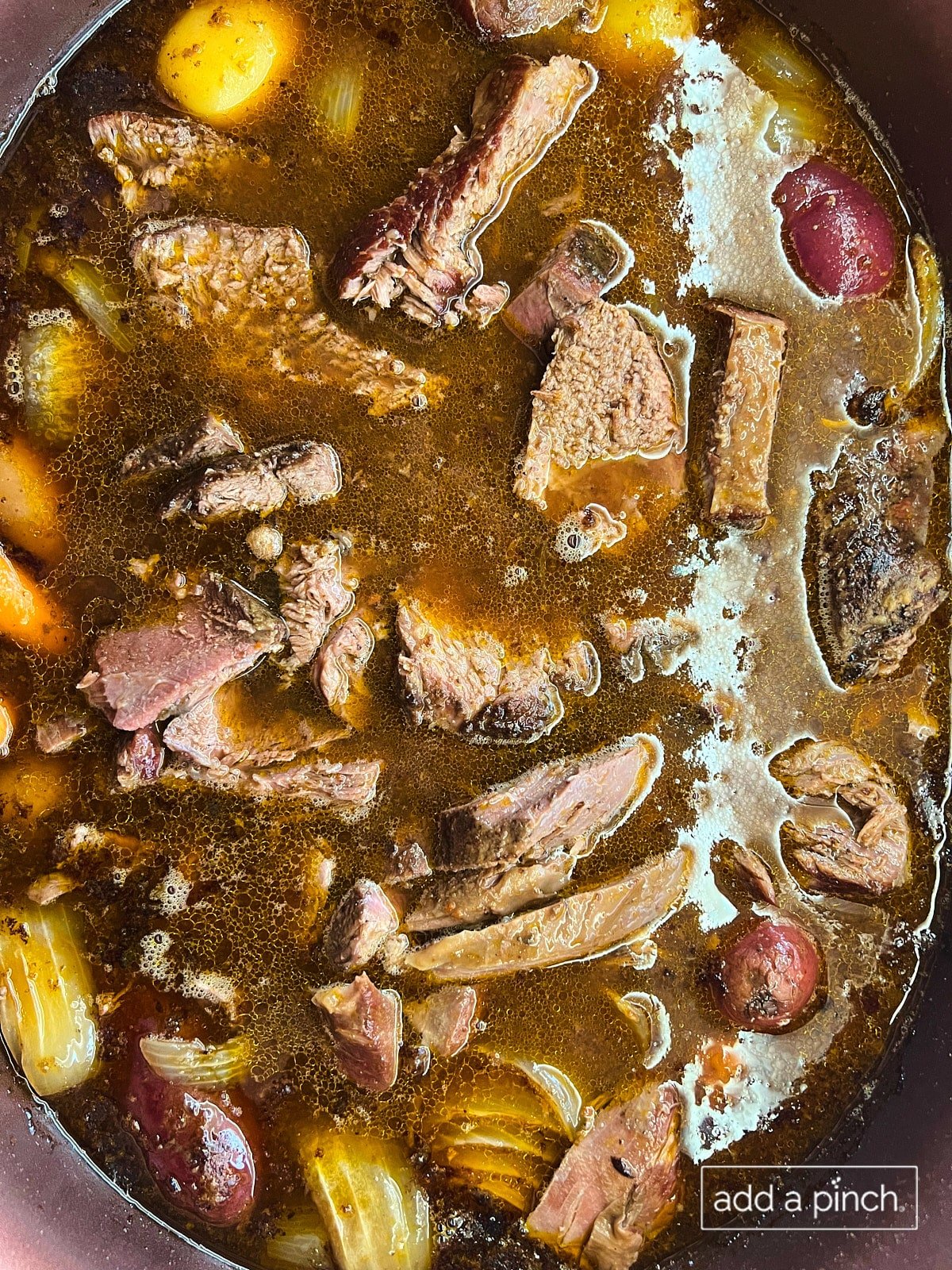 Chopped deer roast added back to stew in the slow cooker.